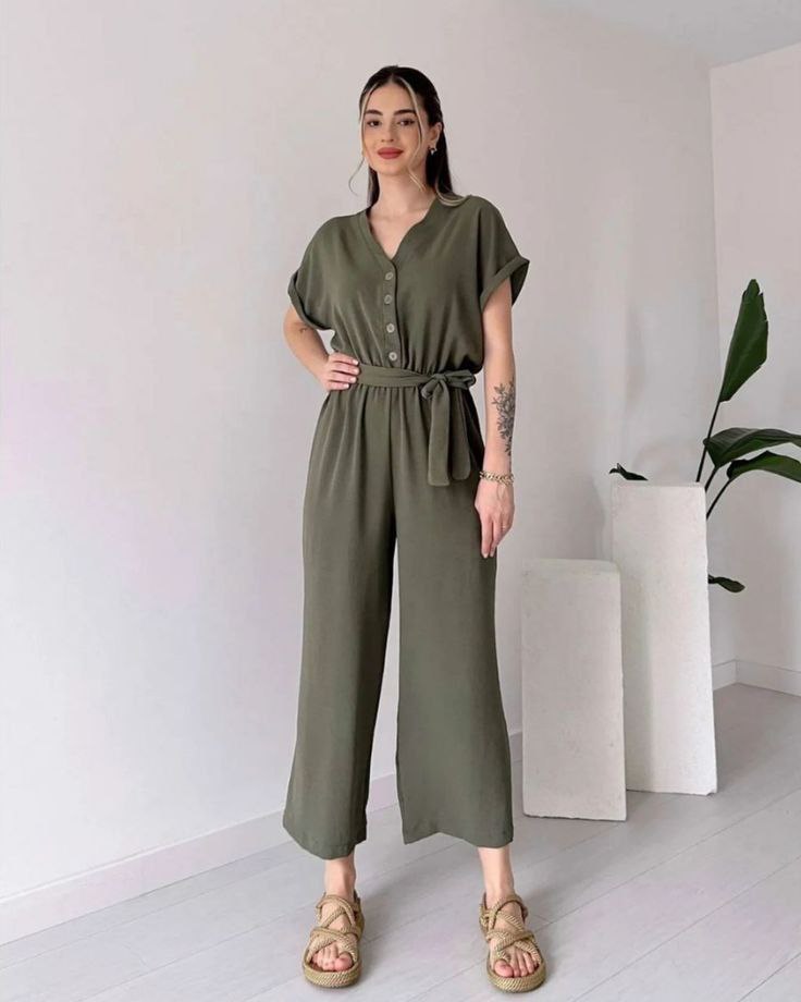 "Sleeveless V-neck red jumpsuit with a belt"