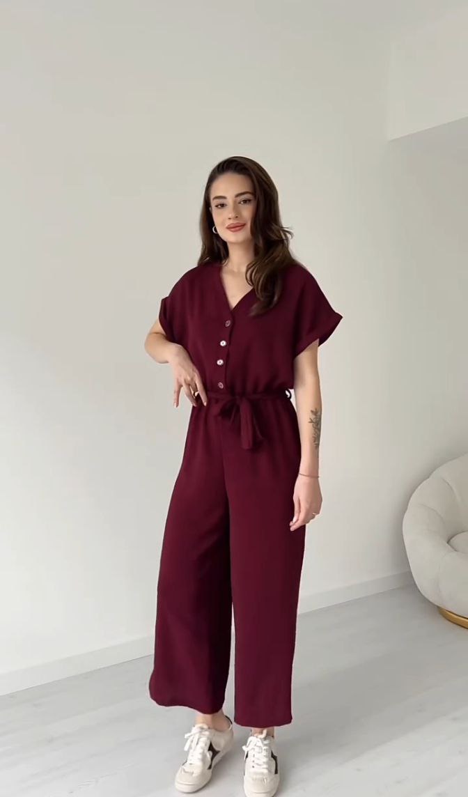 "Sleeveless V-neck red jumpsuit with a belt"