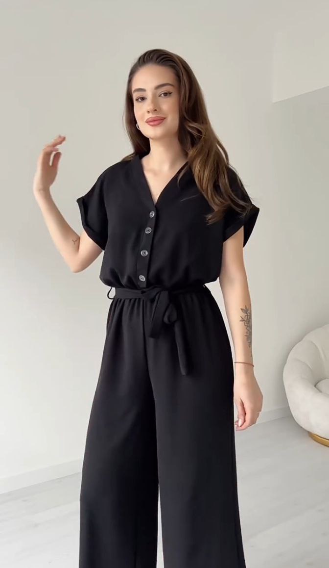 "Sleeveless V-neck red jumpsuit with a belt"