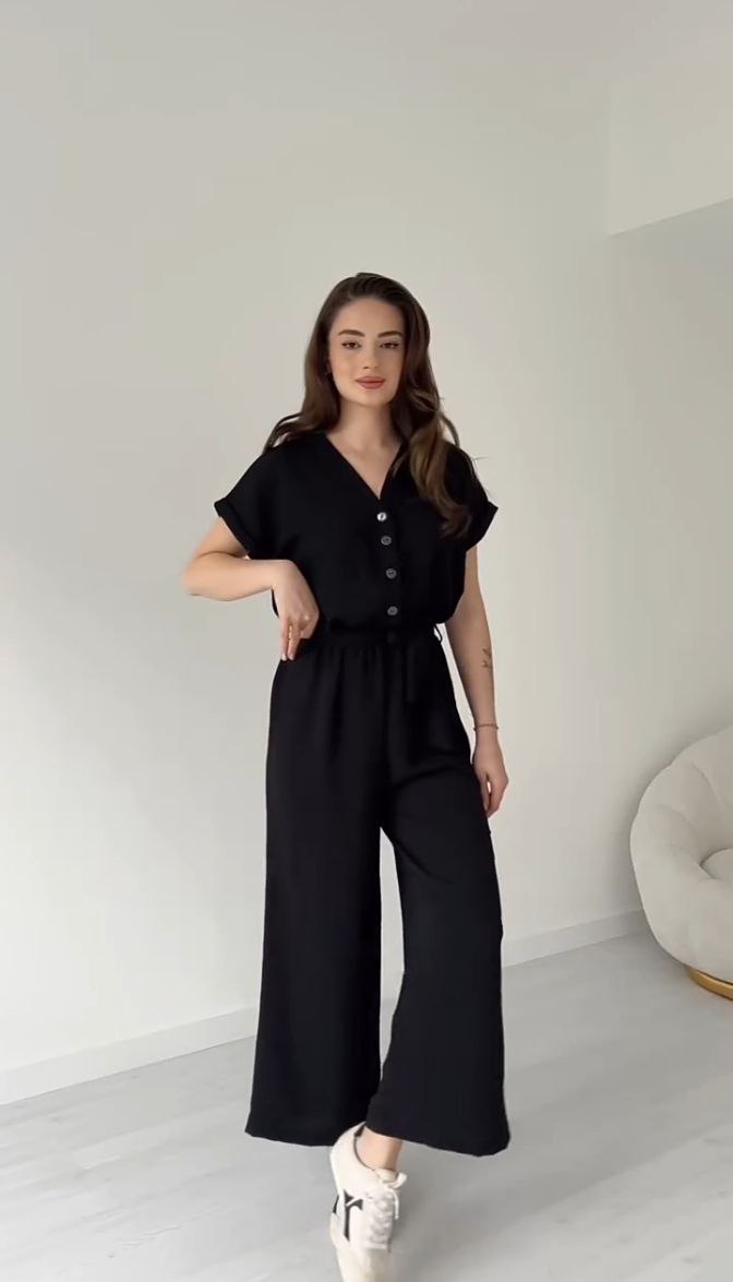 "Sleeveless V-neck red jumpsuit with a belt"