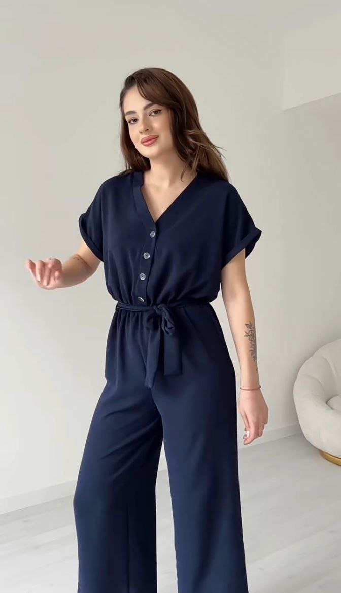 "Sleeveless V-neck red jumpsuit with a belt"