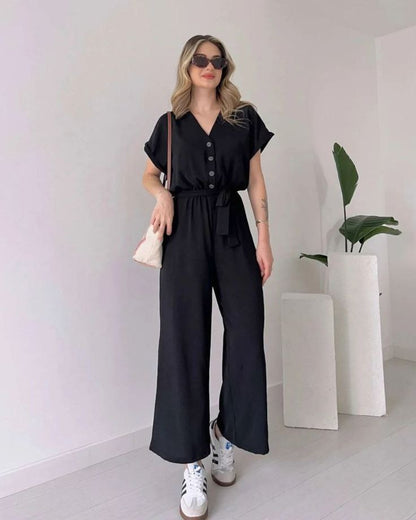 "Sleeveless V-neck red jumpsuit with a belt"